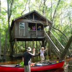 Carolina Heritage Outfitters in St. George, South Carolina offers outdoor adventurers the opportunity to paddle a two-person canoe along the cypress-lined, rapid-free, blackwater Edisto River to three private treehouses for overnight stays.