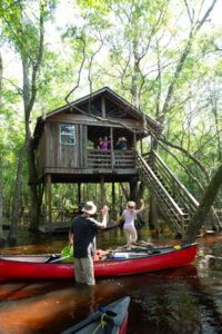 Carolina Heritage Outfitters in St. George, South Carolina offers outdoor adventurers the opportunity to paddle a two-person canoe along the cypress-lined, rapid-free, blackwater Edisto River to three private treehouses for overnight stays.